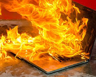 Laptop computer on fire and burning furiously