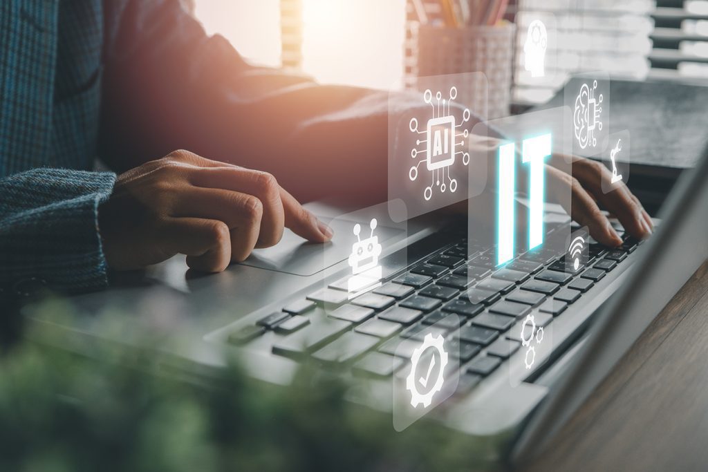 Someone working on a laptop with images relating to managed IT services overlaid.